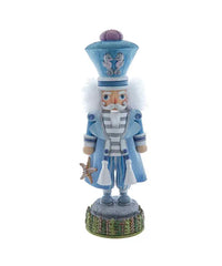 Blue coastal nutcracker featuring a captain’s hat, seahorse accents, and starfish detail, perfect for nautical Christmas decor.