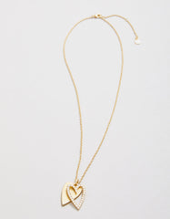 Happy Heart Necklace featuring two layered hearts with glass crystals in 18kt matte gold.