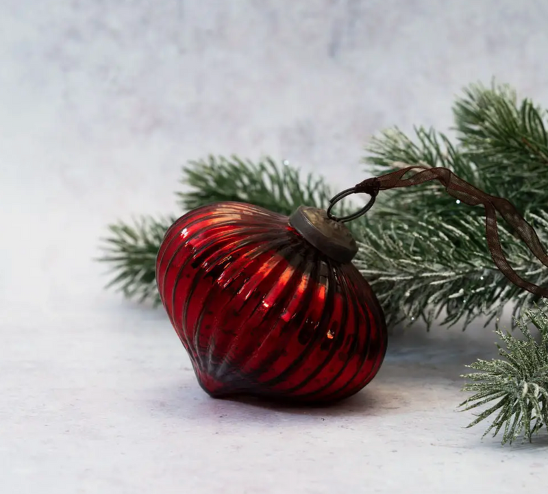 3" Wine Ribbed Lantern Ornament resting on a frosted pine branch with intricate cap details and mouth-blown glass design.