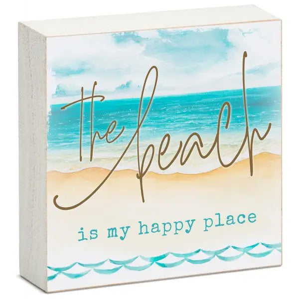 A decorative wooden sign featuring an illustration of a serene beach scene with blue skies, white clouds, and calm ocean waves. The text reads, "The beach is my happy place" in a combination of elegant cursive and playful print, capturing the essence of coastal relaxation and beach-inspired joy.