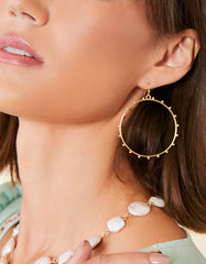 Bobbi Earrings featuring textured 18kt matte gold-plated hoops.