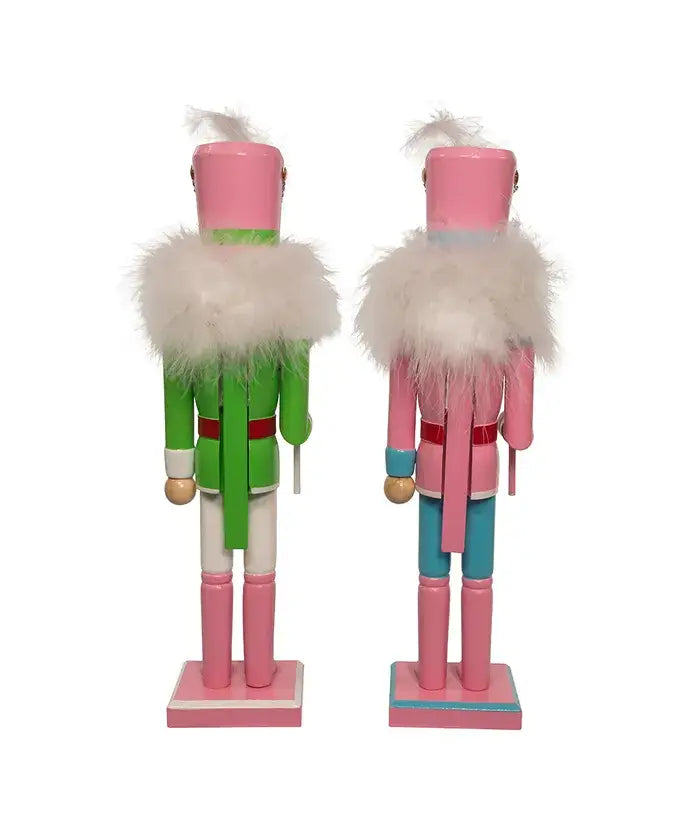 Two colorful nutcrackers with pink and green outfits on a white background