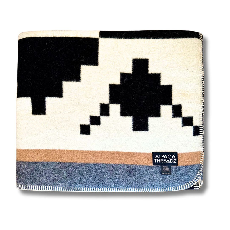 Folded corner view of the Black/White geometric alpaca blanket variant, showing the stark contrast.