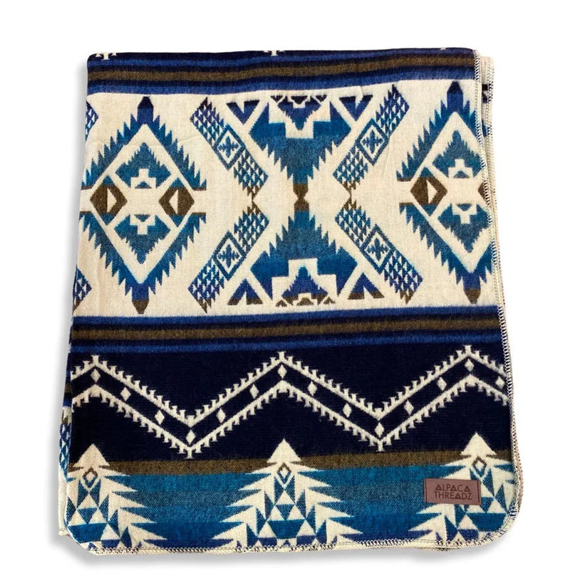 Blue/Cream Alpaca Baby Blanket folded into a square, detail shot showing the bright white and deep blue pattern.