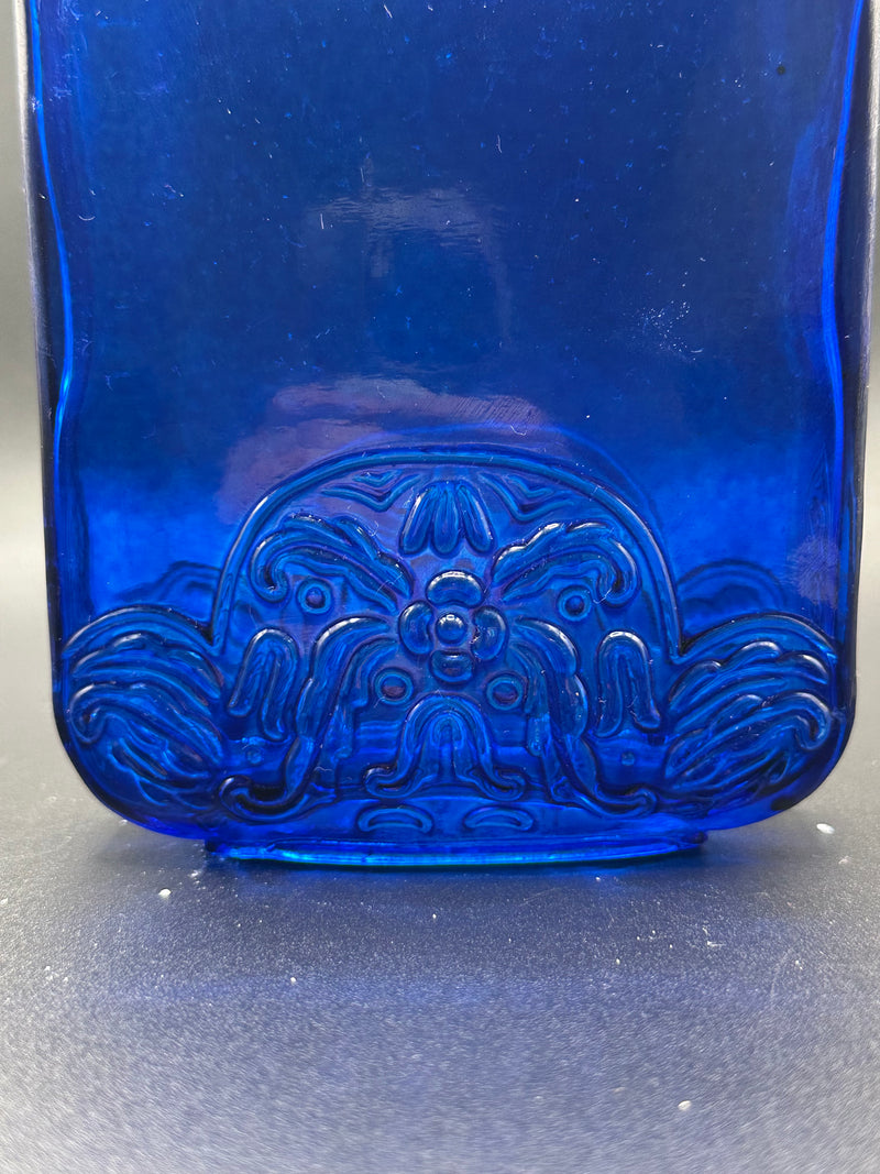 Close up of the design on the blue bottle.