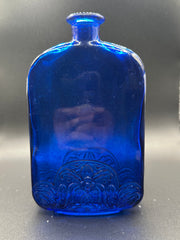 The Blue Bottle under a light.