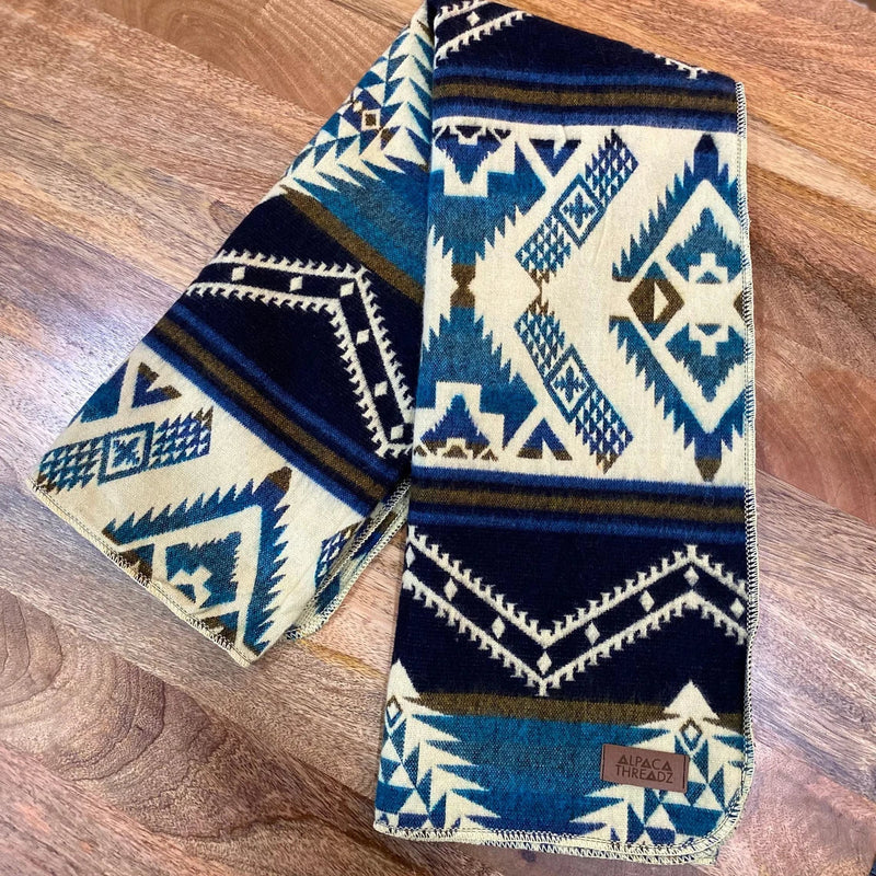 Close-up of the geometric-patterned Blue/Cream Luxury Alpaca Baby Blanket, showcasing the ultra-soft texture.