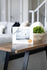 Book titled 'Nails and Son' on a wooden table with a blurred background