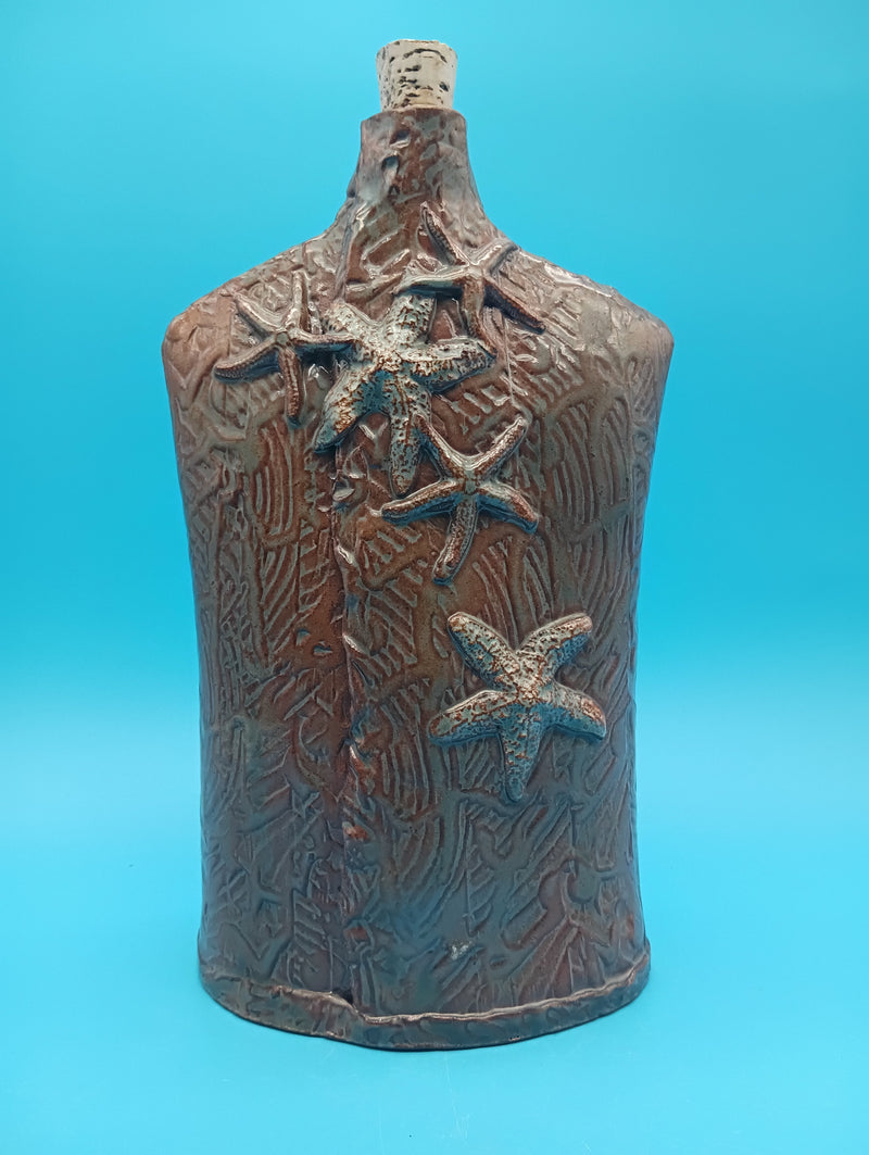 Ceramic vase with starfish accents in rustic coastal style – home decor accessory