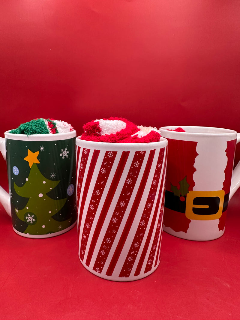 Group of festive Christmas mugs including tree, candy cane, and Santa designs displayed on red background.