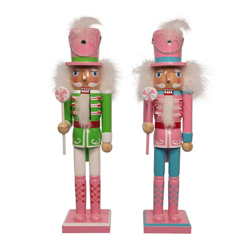 Two nutcrackers in pink and green outfits on a white background