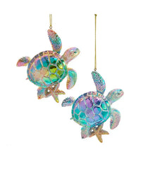 Two iridescent turtle ornaments hanging against a white background