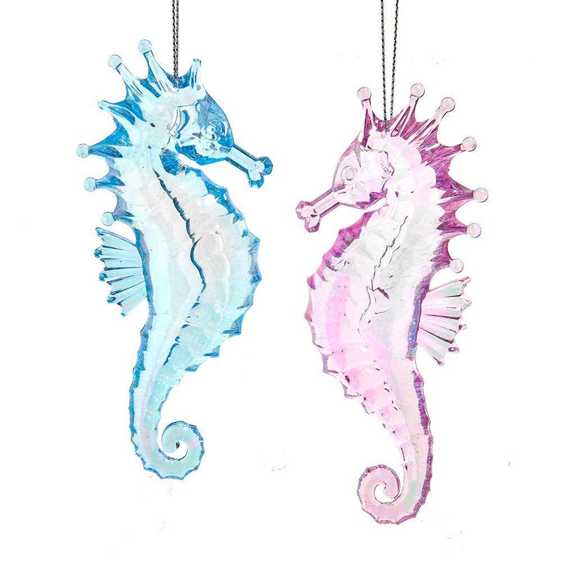Two seahorse ornaments, one blue and one pink, on a white background.