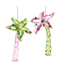 Two decorative palm tree ornaments with lights on a white background