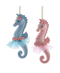 Two decorative seahorses, one blue and one pink, with floral crowns and tulle skirts on a white background.