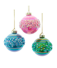 Three colorful glass ornaments with sequin embellishments on a white background