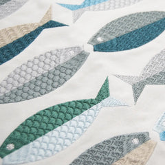 Close-up of the intricate fish embroidery on the Sea Glass Fish Pattern Pillow, highlighting its coastal colors and detailed stitching.