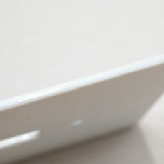 Close-up of the ceramic switch plate with detailed wave design and 