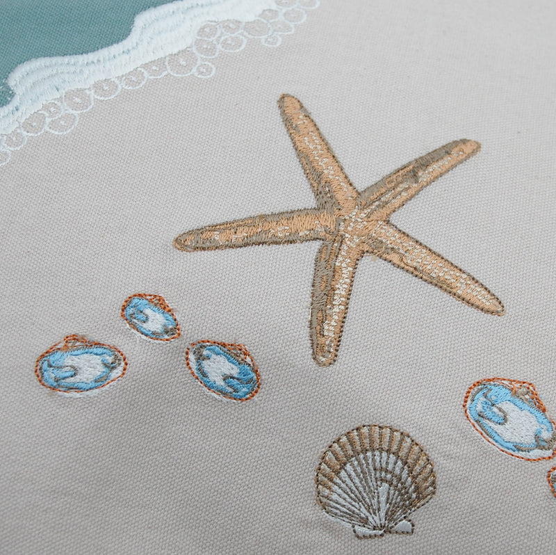 Close-up of the embroidered starfish and shell details on the Sand & Shells Table Runner, highlighting its intricate craftsmanship.