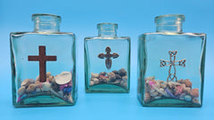 Coastal-style glass decor with cross symbol and natural shell fill – religious accent piece
