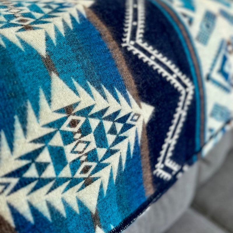 Close-up of the Cobalt Blue blanket's corner, focusing on the sharp lines of the geometric pattern and the contrast between the blues and white.