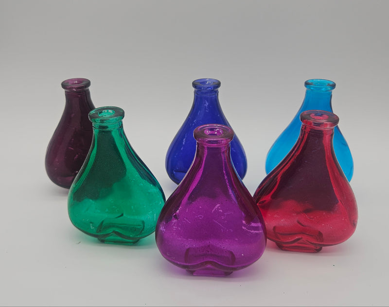 Set of colorful glass bottles – coastal décor accents in aqua, blue, pink, red, green, and purple