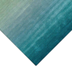 A corner of the  luxurious blue ombre indoor rug measuring 5'x7'6