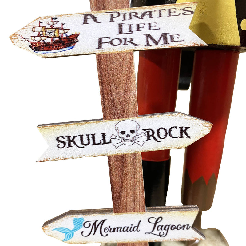 Close-up of wooden sign reading A Pirate’s Life for Me Skull Rock and Mermaid Lagoon attached to pirate nutcracker base