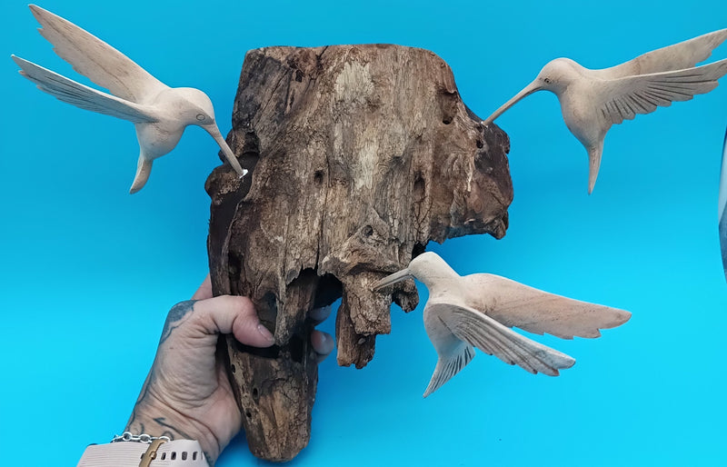 Driftwood wall art with hand-carved hummingbirds in rustic coastal style – decorative accent