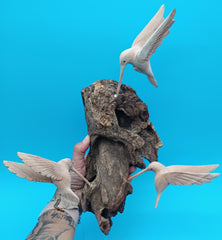 Driftwood wall art with hand-carved hummingbirds in rustic coastal style – decorative accent