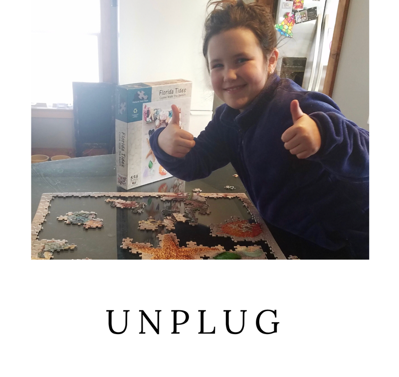 A family member enjoying assembling the Seashell Collection puzzle with enthusiasm and a smile.
