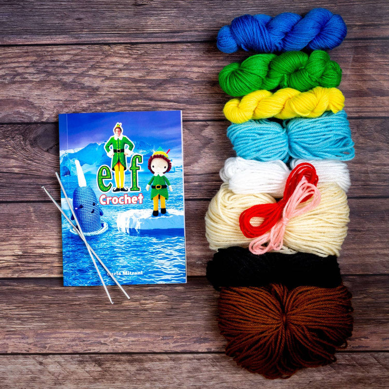 Colorful yarn skeins with a crochet book on a wooden surface