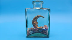 Glass bottle with crescent moon in nautical style – coastal home decor accessory