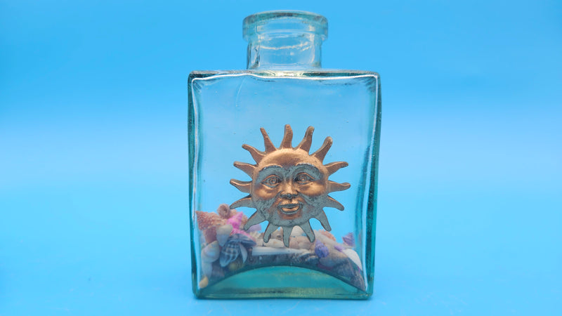 Glass bottle with sun face in vintage style – coastal home decor accessory