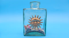 Glass bottle with sun face in vintage style – coastal home decor accessory