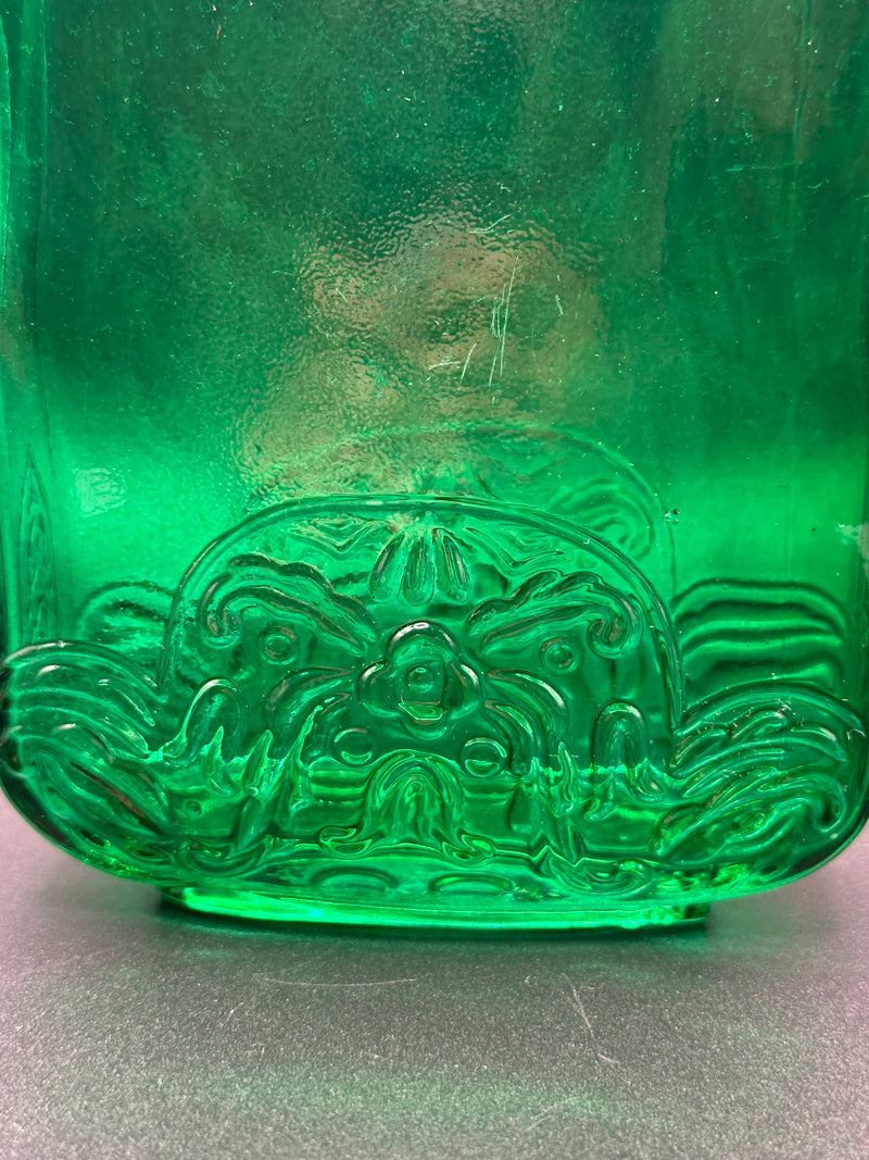 Close up of the design on the green bottle.