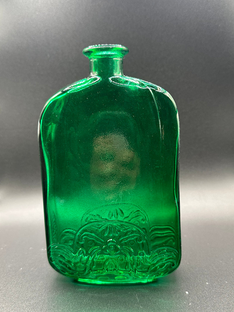 The Green Bottle under a light.