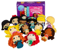 Collection of Disney Princess crochet dolls in front of a Disney Princess crochet kit box.