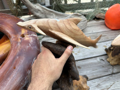 Close-up of Hammerhead Driftwood Sculpture on a rustic wood surface