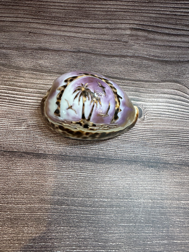 Hand-carved Cowry Shell with palm trees and seagulls.