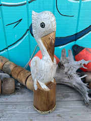 Wooden Pelican Standing on Piling Statue