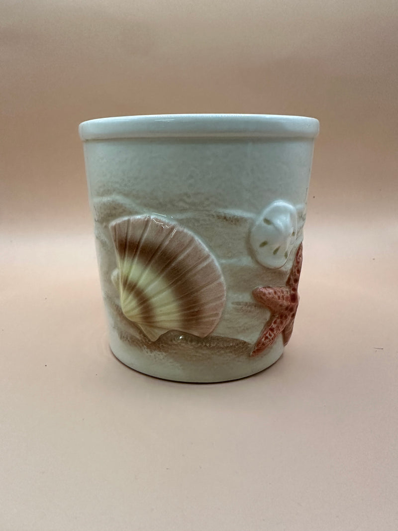 Front view of Vintage Shell Ceramic Planter with embossed seashell and starfish designs.