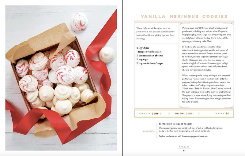 Vanilla meringue cookies in a box with red ribbon on a white surface, next to a recipe for vanilla meringue cookies.