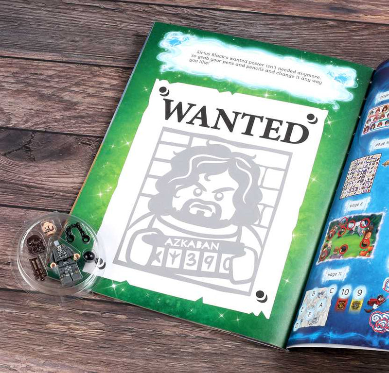 Open book with a 'Wanted' poster and LEGO figure on a wooden surface