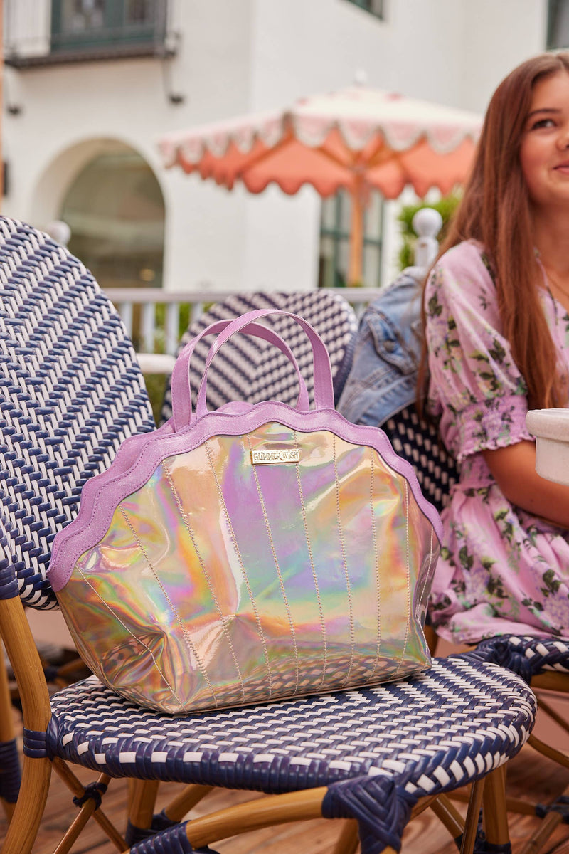 Holographic handbag on a chair with a person sitting in the background