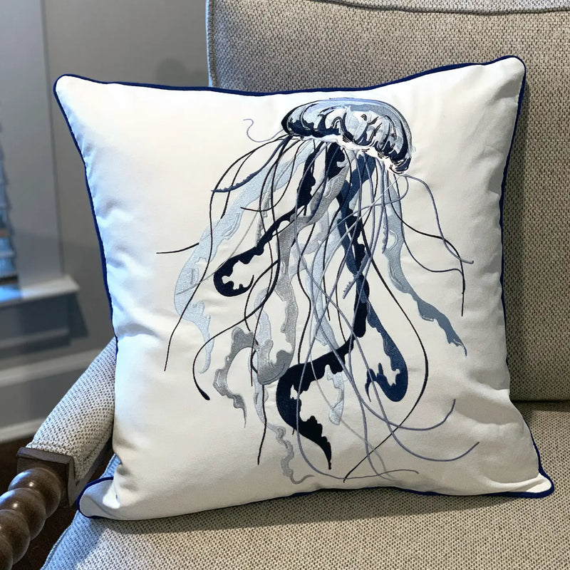 Blue Jellyfish Embroidered Pillow styled on a sofa, blending beautifully with indoor coastal decor.