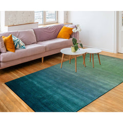 A luxurious blue ombre indoor rug measuring 5'x7'6