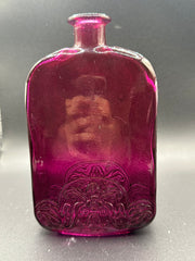 The Magenta Bottle under a light.