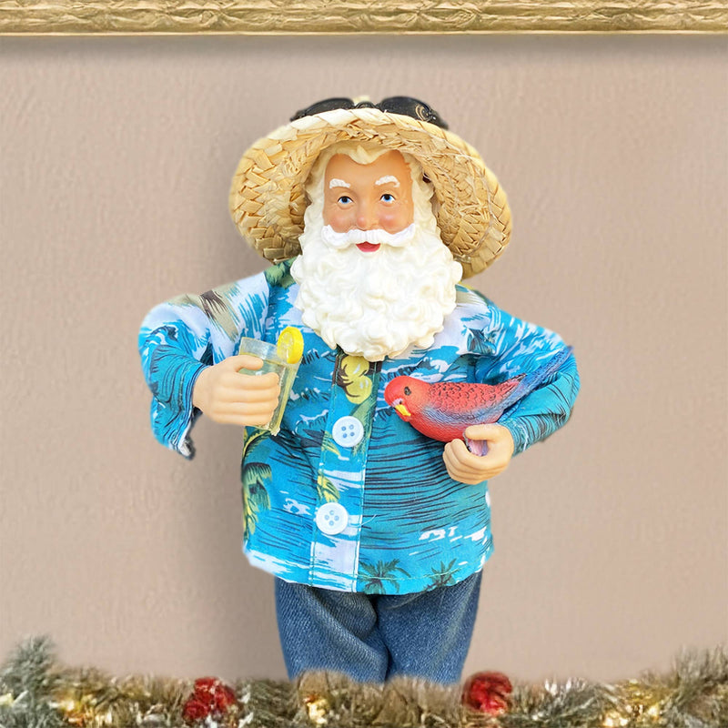 Santa figurine in blue Hawaiian shirt standing among Christmas greenery coastal holiday décor
