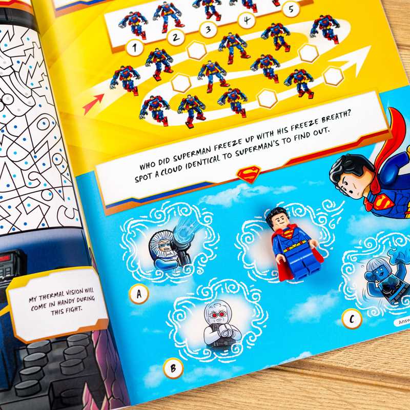 Superman-themed activity book with coloring and puzzle pages on a wooden surface